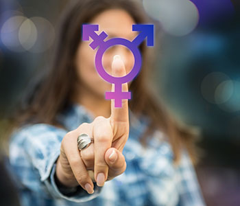 young women with finger on transgender symbol for transgender voice training